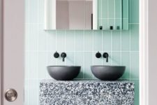 16 green tiles and a terrazzo sink stand in grey, black and white for an eye-catchy touch
