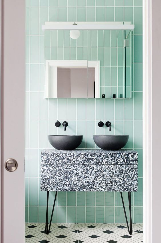 green tiles and a terrazzo sink stand in grey, black and white for an eye-catchy touch