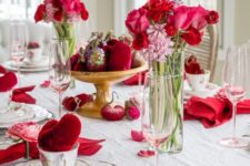 16 red velvet hearts for table decor and place settings, red napkins with pink blooms and bold floral centerpieces