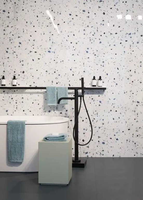 white, blue and purple terrazzo plus a free standing bathtub and some clean lines for an ultra modern look in the bathroom
