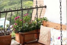 07 a swing bench, a wooden table and wooden planters that match the furniture look