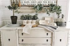 potted greenery and garlands for stylish an elegant farmhouse console table