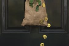 12 a burlap sack with fresh shamrocks, a green bow and gold coins on the sack and door