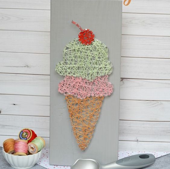 a pastel ice cream cone string art with a cherry on top