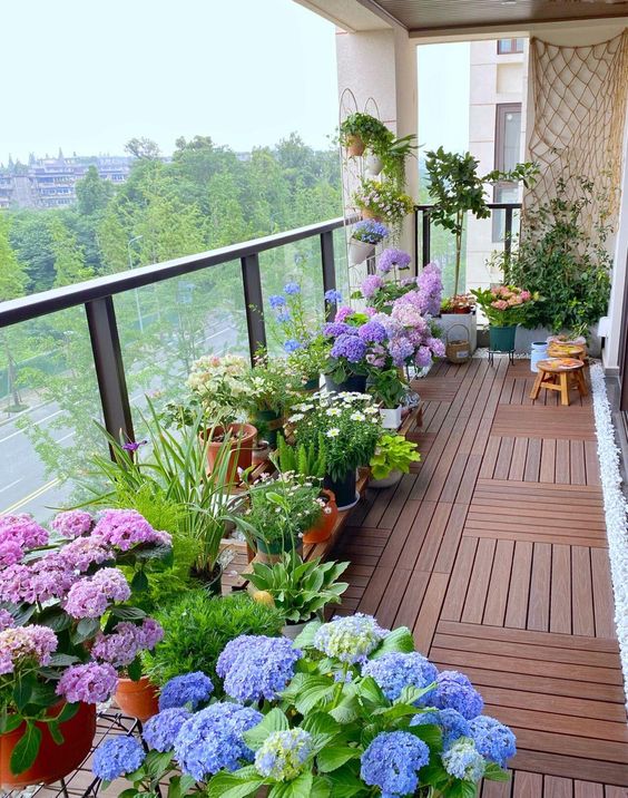 a bright spring balcony with no furniture, just potted flwoers and greenery, resembles of a blooming garden