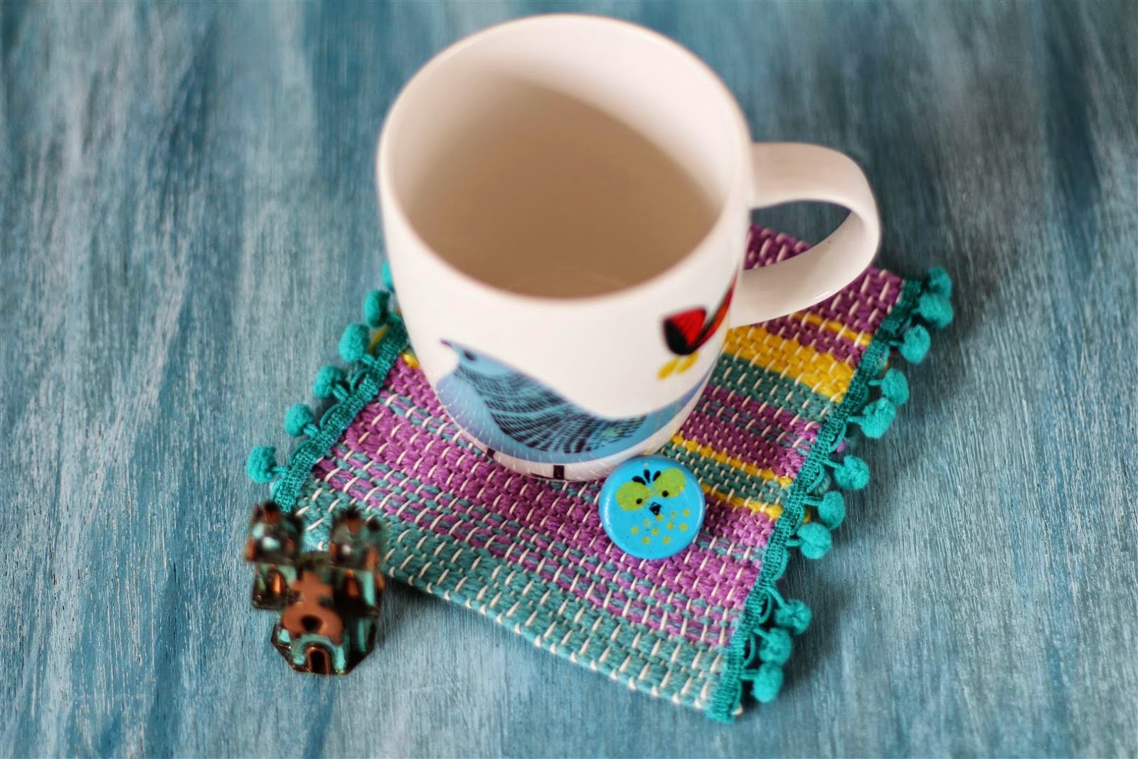 DIY woven loom mat coaster with pompoms