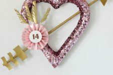 DIY pink sequin heart wreath with a gold arrow for Valentine’s Day