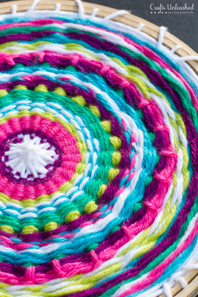 DIY super colorful wall hanging with an embroidery hoop (via blog.consumercrafts.com)