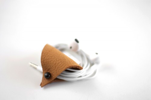 DIY triangle leather ear bud holder (via www.shelterness.com)