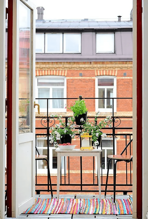 potted greenery and blooms attached to the railing won't take any space and will feel like spring