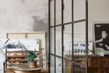 02 a black framed glass divider separates a small breakfast nook and the living room