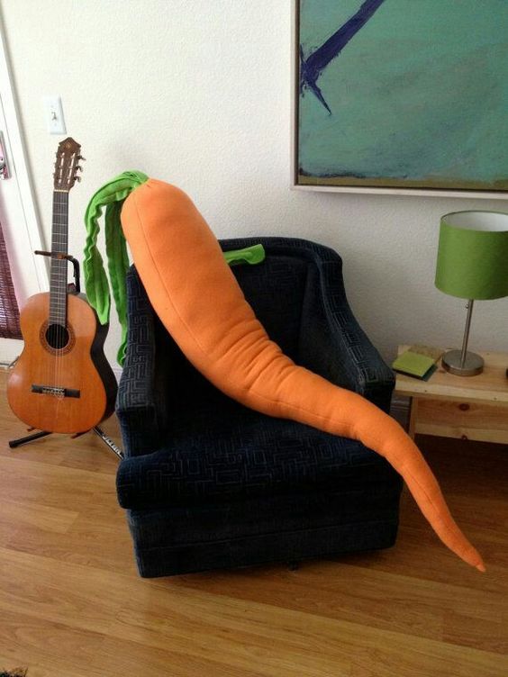 a colorful carrot pillow is useful for sleeping and just having fun with it