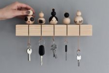 a key rack with key rings inspired by Japanese kokeshi dolls