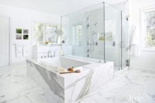 05 white marble used throught the space and to cover the bathtub looks very refined