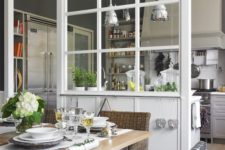 06 a framed glass space divider separates the dining space and kitchen very delicately