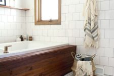 08 a rich-colored wood clad tub stands out in a neutral bathroom, and a colorful rug matches