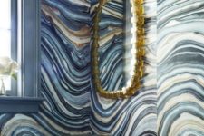 spruce up your bathroom with agate print wallpaper and a gold framed mirror