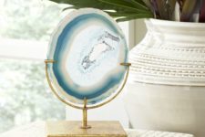 12 a gorgeous slice of blue agate is mounted on an aged, golden stand to offer natural beauty