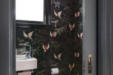 black wallpaper with bold red bird prints to make the powder room wow