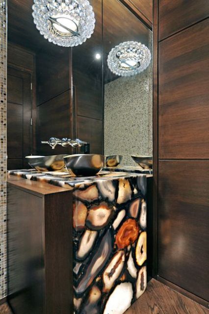 a contemporary powder room with an agate clad sink stand lit from the inside