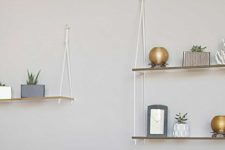 DIY lucite hanging shelves with a gold edge and ropes