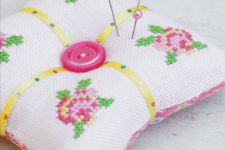 DIY cross stitched roses pincushion with a large button