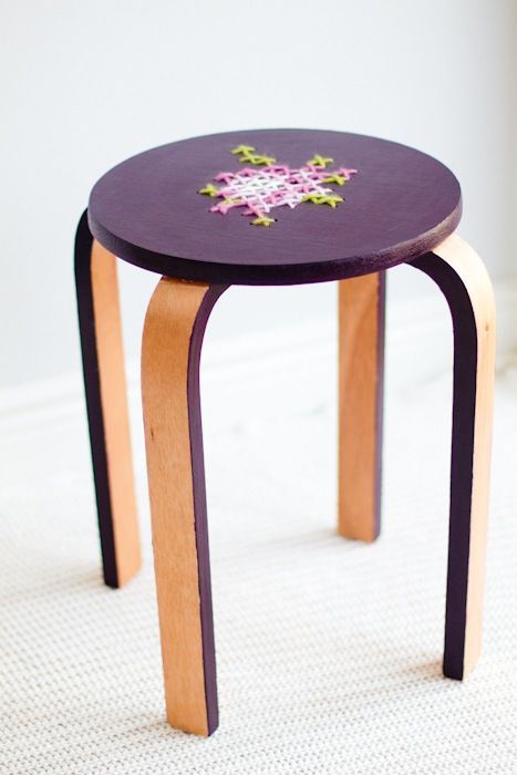 a bold purple Frosta stool with floral embroidery on top for a unusual touch