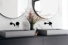 14 concrete sinks and a pink leather upholstered stool add style to the bathroom