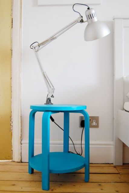a bold blue IKEA Frosta stool with a shelf is a functional and colorful nightstand or side table