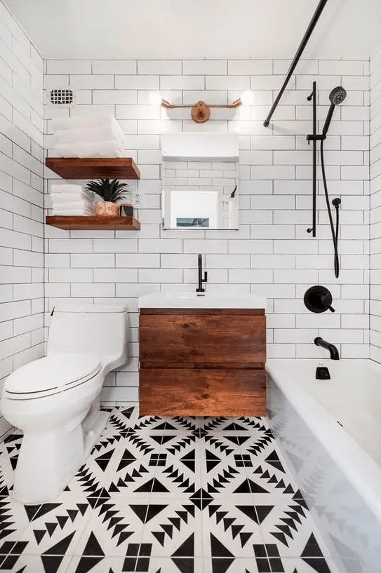 a small and chic modern bathroom with a mosaic floor, a floating wooden vanity, open shelves, a tub and white subway tiles