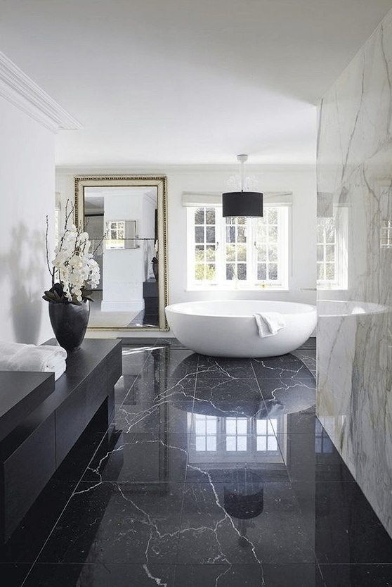 black marble tiles on the floor bring luxury and chic, and white marble tiles on the walls just add to it