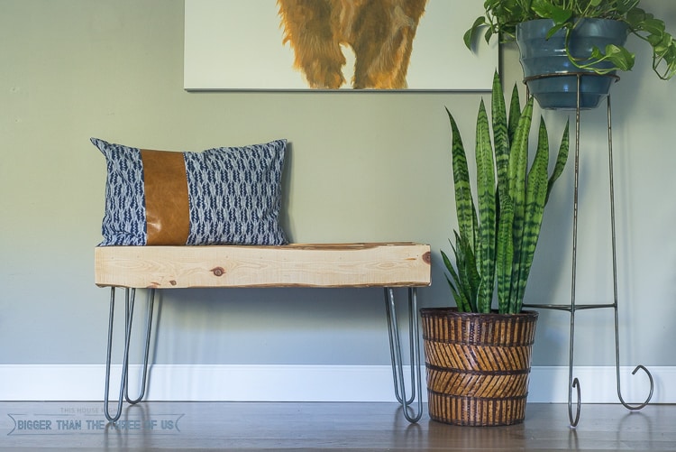 DIY wooden entryway bench with a rough wooden slab seat
