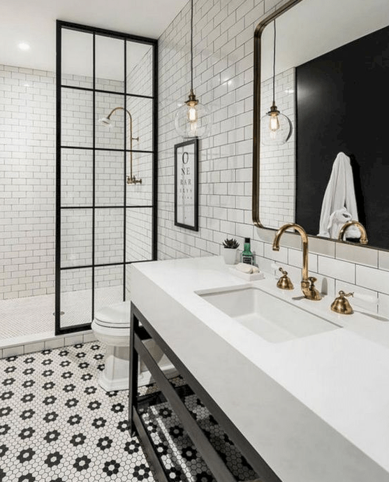 hex penny tiles forming floral patterns on the floor and neutral white subway tiles with black grout on the walls