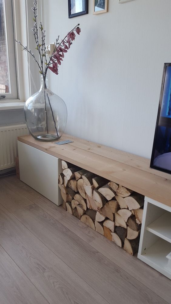 IKEA Besta console with a drawer, open storage and some firewood storage, which serves for decor