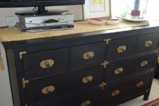 09 a black Hemnes dresser with brass corners, knobs and framing for a chic look