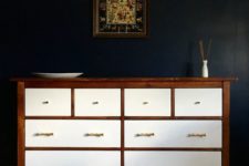 11 a dark stained IKEA Hemnes dresser with white drawers and brass handles for a contrasting look