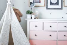 an ombre peachy pink IKEA Hemnes dresser with black knobs for a girl’s room