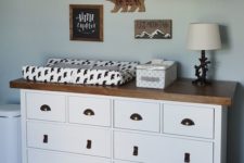 25 Ikea Hemnes dresser with leather pulls and metal handles and a wooden top for a rustic changing table