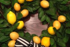 DIY faux greenery and lemon wreath with a striped bow
