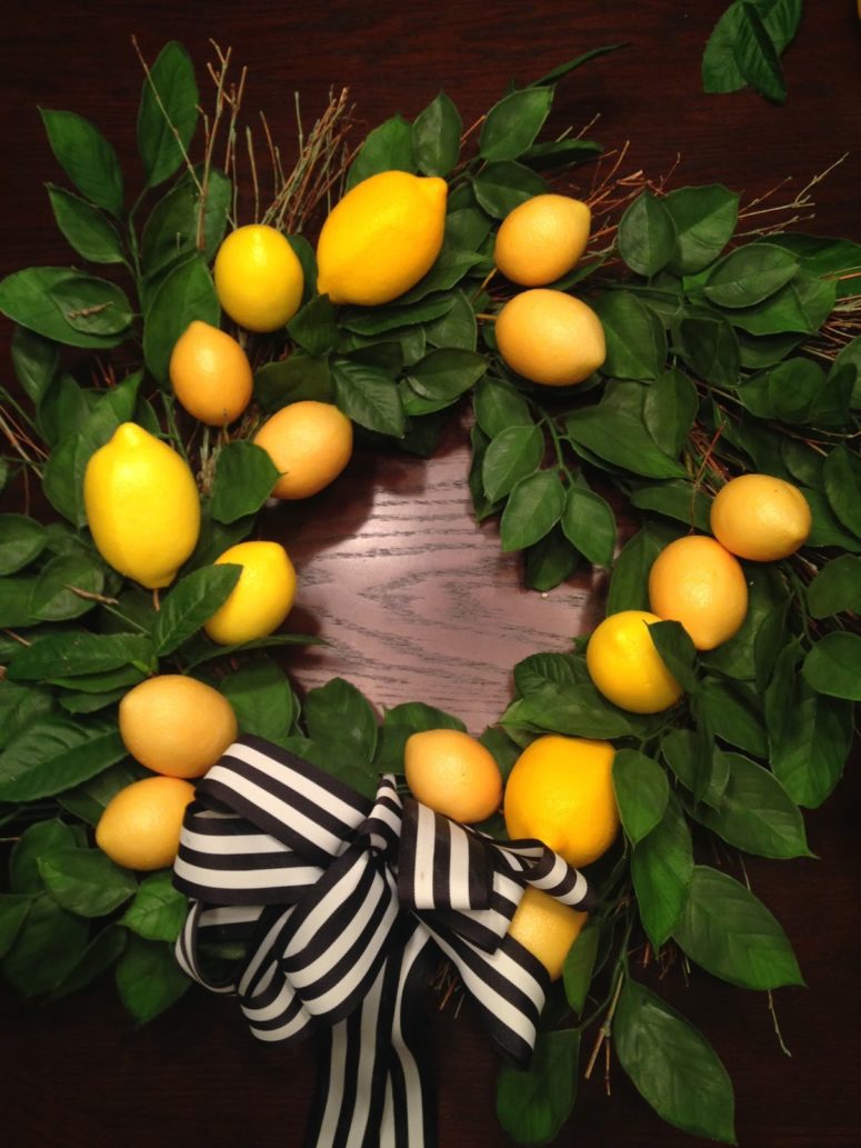 DIY faux greenery and lemon wreath with a striped bow (via www.chroniclinghome.com)