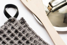 DIY dark waffle crochet potholder with a leather loop