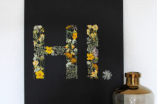 modern DIY black artwork with pressed flower letters