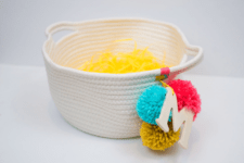 DIY rope basket with a monogram and colroful pompoms