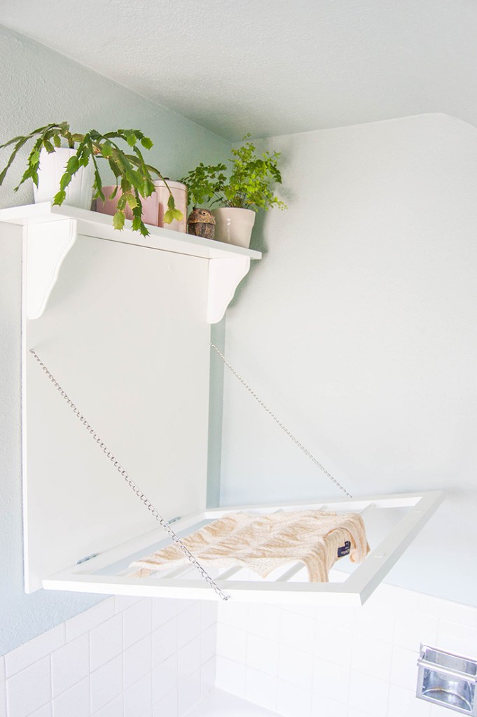 DIY laundry rack with a shelf on top