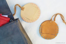DIY round leather luggage tags with stitched edges and opened parts