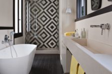 08 a chic monochromatic space with geometric mosaic tiles in the shower and colorful accents