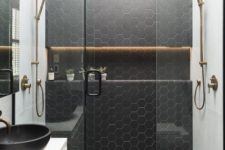 09 a contemporary bathroom with black hexagon tiles and white grout on the wall and floor