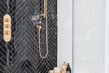 13 a statement wall of black tiles clad in a chevron pattern and done with white grout for an elegant feel