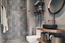 16 mosaic black and white tiles covering the shower wall and floor make it stand out