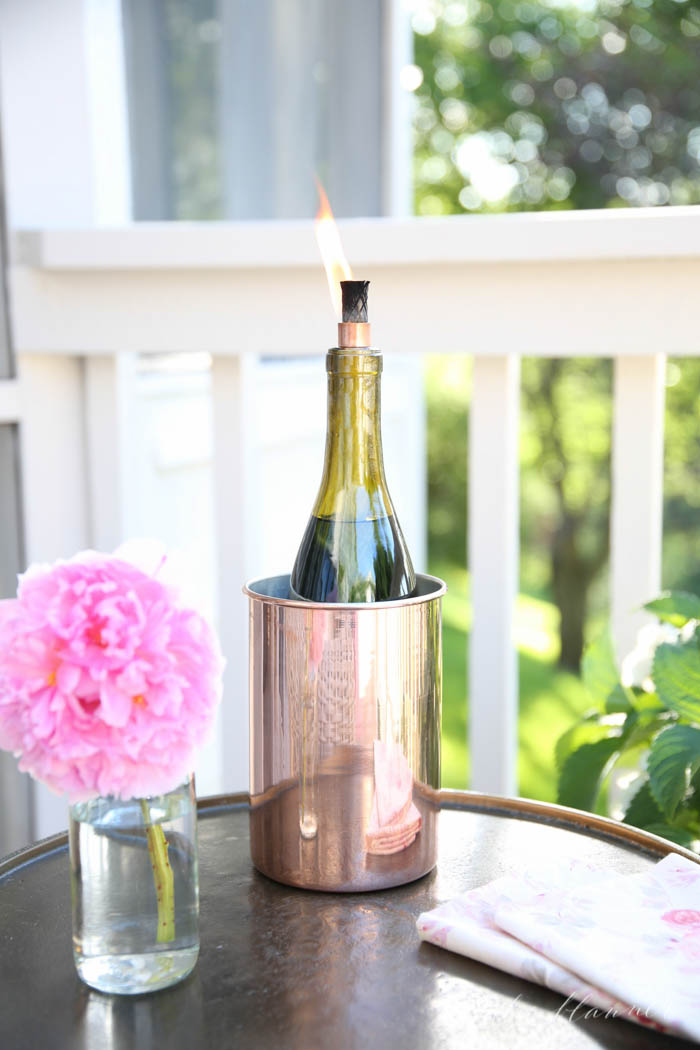 DIY wine bottle tiki torch in a copper bucket (via julieblanner.com)